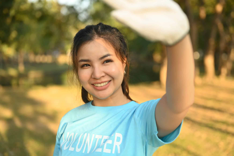 positive-asian-female-volunteer-cleaning-up-nature-2024-01-09-12-49-38-utc.webp